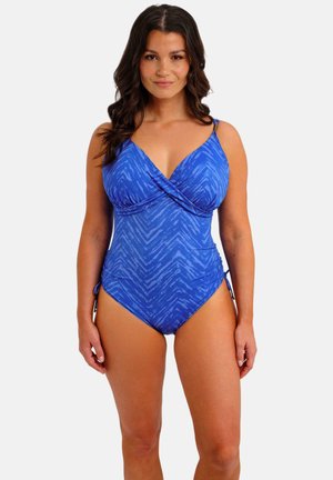 Maillot de bain une pièce bleu avec un design croisé, motif en zigzag, bretelles ajustables et liens latéraux pour un ajustement personnalisé. Matière extensible.