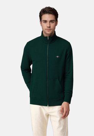 Gecombineerde hoodie met rits in donkergroen, met een hoge kraag, geribbelde manchetten en zoom, en een klein logo op de borst.