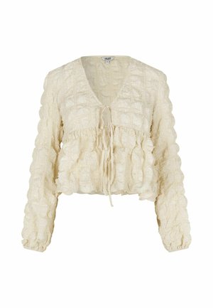 Kremowa, krótka bluzka z dekoltem w kształcie litery V, z wiązaniem z przodu oraz fakturowanymi falbanami. Długie rękawy z marszczonymi mankietami.