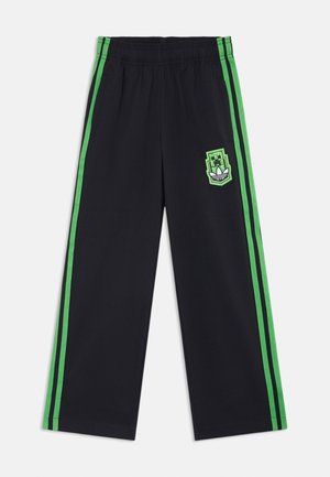 Pantalon noir à jambes larges avec des bandes latérales vertes et un patch logo pixellisé vert sur la cuisse gauche, taille élastique.