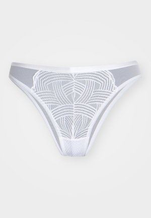 Bílý tanga s krajkovým designem, obsahující geometrický vzor. Měkký, průhledný materiál s hladkým pasem a minimalistickým střihem.