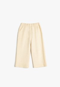 Hellbeige weite Beinhosen aus strukturiertem Stoff, mit einem elastischen Bund und seitlichen Taschen. Quadratischer Saum am unteren Ende.