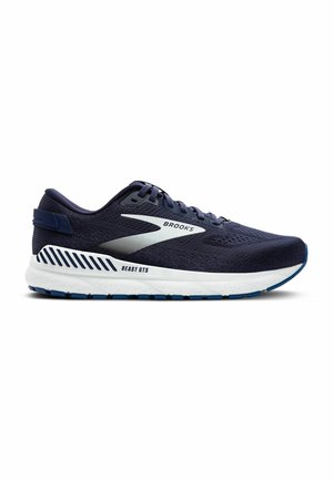 Marine-Laufschuhe mit atmungsaktivem Obermaterial aus Mesh, abgerundeter Zehenpartie, weißer Zwischensohle und blauer Gummisohle. Mit Brooks-Logo und Detail "BEAST GTS".