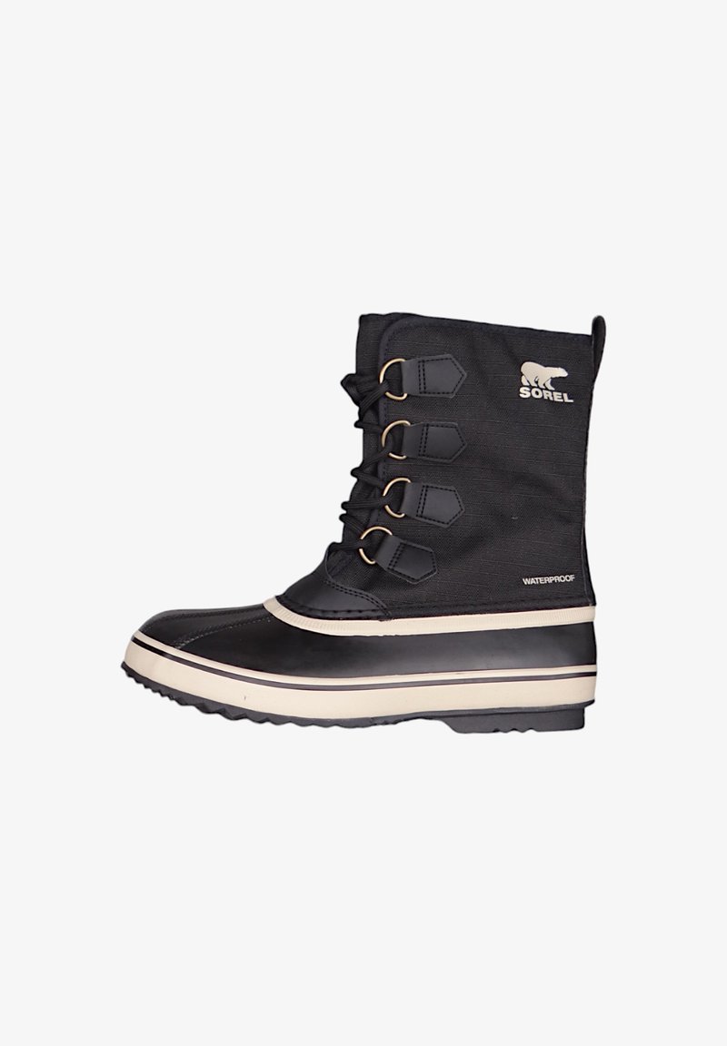 Botte noire imperméable avec tige en tissu, semelle en caoutchouc, cinq œillets métalliques et une bande médiane blanche en contraste. Logo de la marque présent.