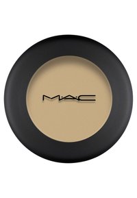Zwarte ronde compact met een getextureerde beige poeder. Het MAC-logo is prominent in zwart op het oppervlak weergegeven.