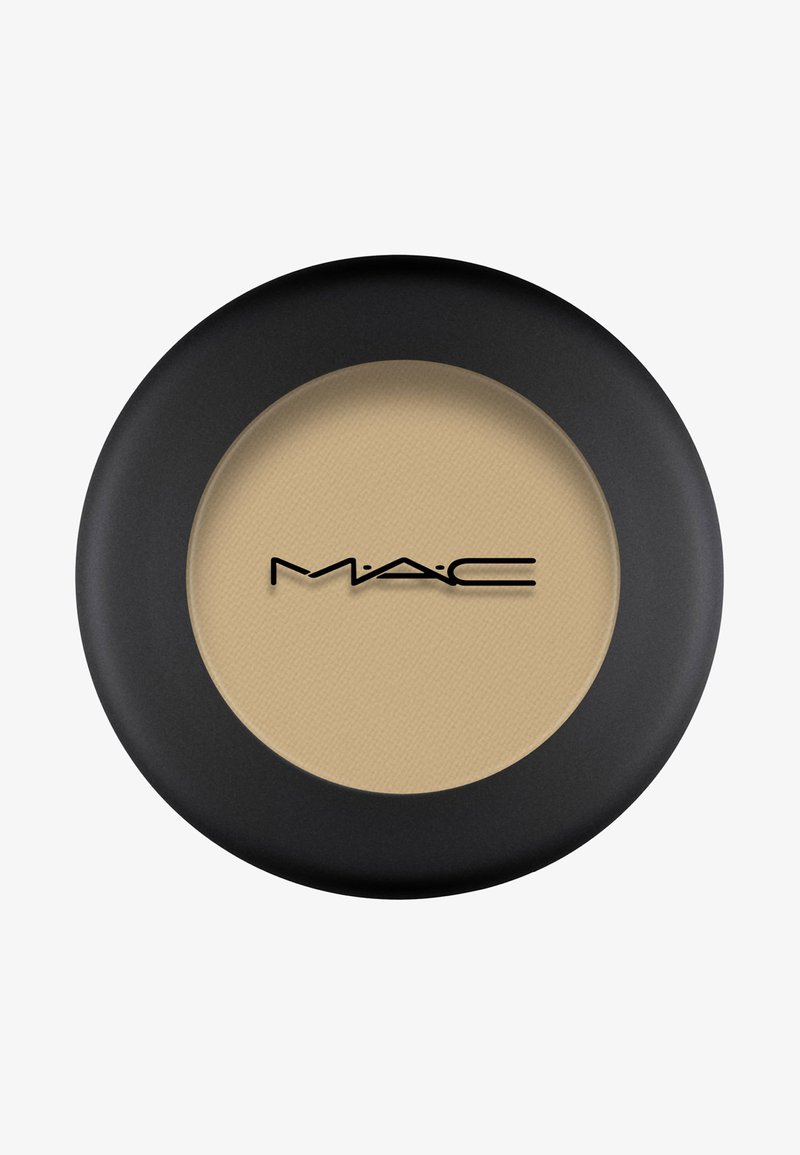 Zwarte ronde compact met een getextureerde beige poeder. Het MAC-logo is prominent in zwart op het oppervlak weergegeven.
