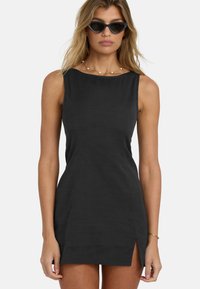 Black sleeveless dress with a fitted silhouette and side split. Made of textured fabric, features a round neckline and minimal design accents.