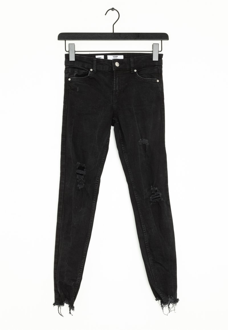 Black denim skinny jeans with rips on knees, frayed hem, and classic five-pocket design. Material appears soft with a slight sheen.