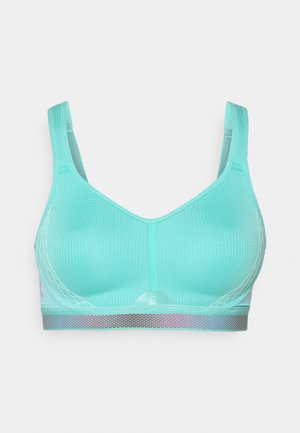 Un soutien-gorge de sport turquoise en tissu texturé, avec des bretelles larges et une bande semi-transparente métallique en bas, ornée d'un motif géométrique.