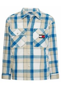 Rutigt skjorta i blått och beige med knäppning fram, två bröstfickor och ett litet logopatch. Tillverkad av ett mjukt bomullsmaterial.