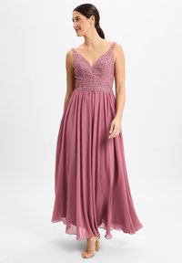 Bodenlanges Kleid in Mauve, mit einem taillierten Oberteil und floralen Stickereien sowie einem tiefen V-Ausschnitt. Fließender Rock mit durchscheinender Textur.