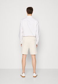 HUGO DIZ - Pantaloni de trening - open white