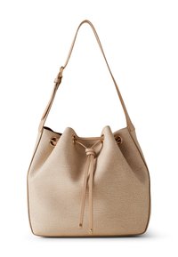 Beige bucket bag made of textured material with a drawstring closure, gold-tone hardware, and a single adjustable shoulder strap.