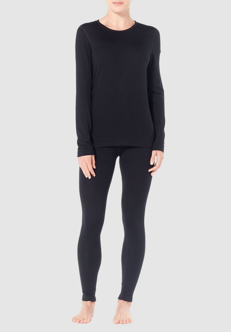 Black long-sleeve top with a round neck, paired with black leggings. Both made of smooth, stretchy fabric. No visible patterns or hardware.