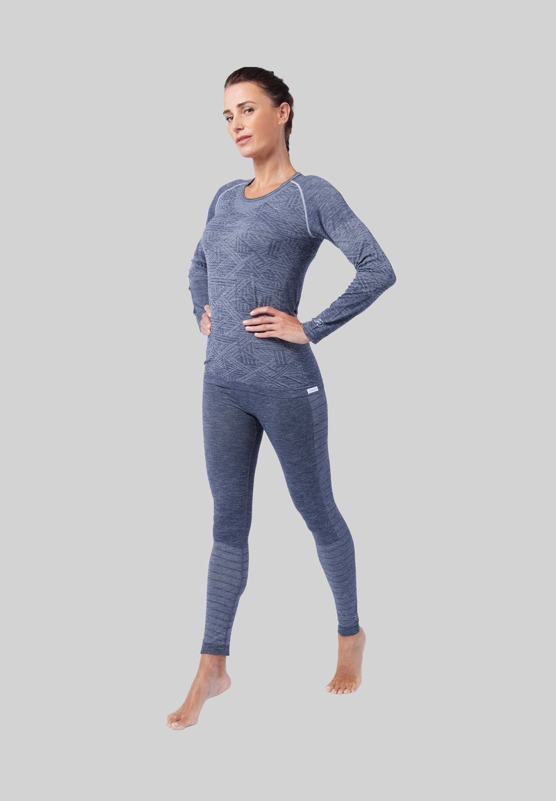 Langermige, aansluitende sporttop en legging in donkerblauw met geometrisch patroon en textuurlijnen. Gemaakt van rekbaar, vochtafstotend materiaal.