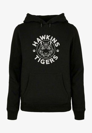 Črna kapuca z motivom tigra in napisom "HAWKINS TIGERS" v beli barvi. Vključuje sprednji žep v obliki kenguruja in kapuco z vrvico.
