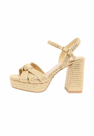 Beige woven platform sandal with block heel, ankle strap, and knotted front straps.