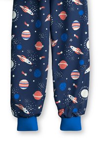 Blue joggers with a space-themed print featuring rockets, planets, and stars on a dark navy background. Elastic cuffs in bright blue.