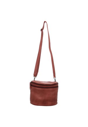 Round brown leather crossbody bag with adjustable strap and top zipper closure against white background.