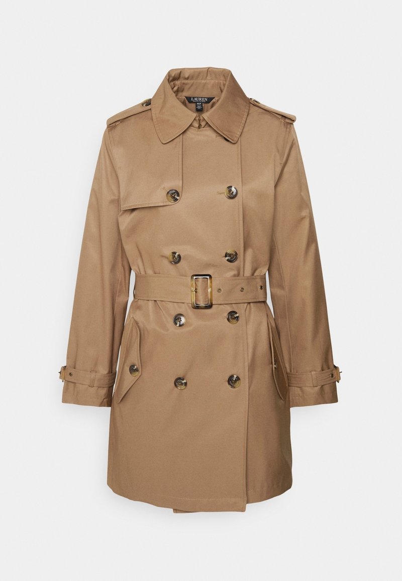 Beige trenchcoat med dubbelknäppt design, axelremmar och bälte i midjan. Har stora knappar och sidofickor. Slät tygstruktur.