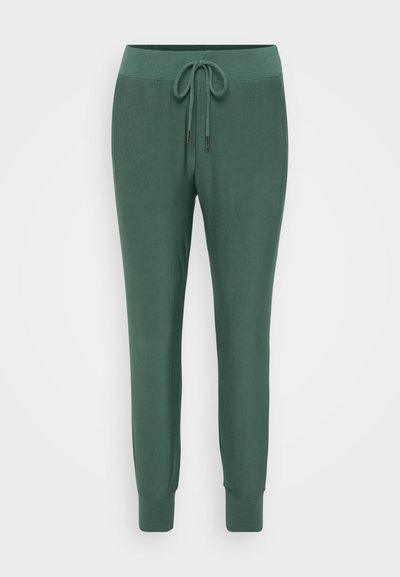 Green jogger pants made of soft fabric, featuring an elastic waistband with a drawstring, tapered legs, and ribbed cuffs at the ankles.