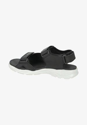 Sandal nero con cinturini regolabili, realizzato in materiale sintetico. Presenta una spessa suola bianca e dettagli intagliati per la traspirabilità.