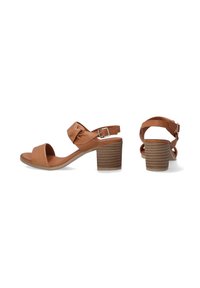 Hellelederne Sandalen mit Absatz und einem verknoteten Oberdesign, offenem Zeh und einem mittelhohen Blockabsatz mit geriffelter Struktur. Verstellbarer Knöchelriemen.