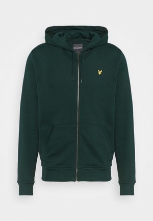 Dunkelgrüner Kapuzenpullover mit Reißverschluss, Fronttaschen, Kordelzug an der Kapuze, gerippten Bündchen und kleinem gelbem Vogel-Logo auf der linken Brust.