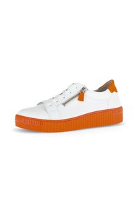 White leather sneaker with orange rubber sole. Features a front lace closure, side zipper, and a contrasting orange heel accent.