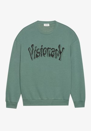 Sweatshirt vert menthe avec un col ras du cou, présentant une typographie noire "Visionary" dans un design fluide. Poignets et ourlet côtelés. Texture douce.