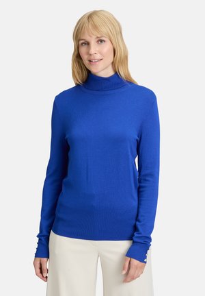 Blauer Wollpullover aus weichem Material mit gerippter Textur. Verfügt über schmal geschnittene Ärmel mit knopfverzierten Manschetten.