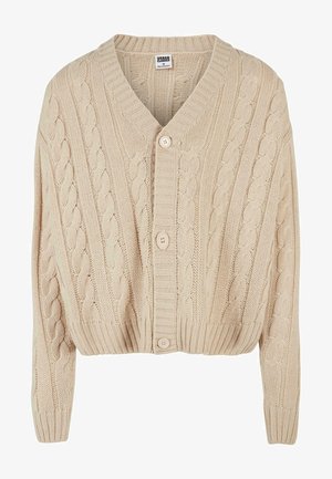 Kremowy sweter z warkoczowym splotem, z dekoltem w szpic, długimi rękawami, zapięciem na pięć guzików i ściągaczem na dole. Posiada teksturowany wzór na całej powierzchni.