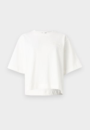 White short-sleeve cropped t-shirt made from soft fabric, featuring a subtle embossed brand logo on the left chest area.