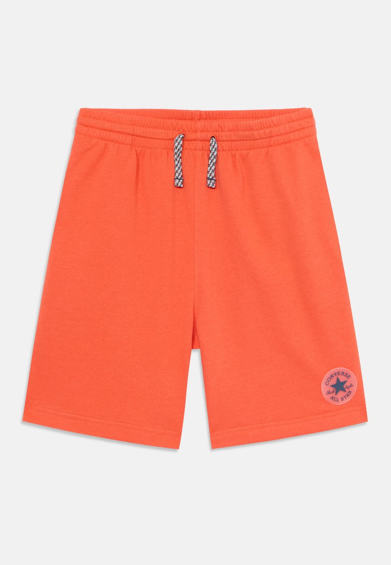 Orange cotton shorts with an elastic waistband, featuring adjustable drawstrings and a blue logo patch on the lower left leg.