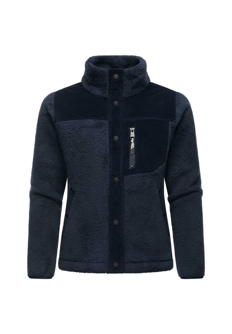 Giacca in pile blu navy con una superficie morbida e testurizzata. Presenta un pannello in cotone a costine, colletto alto, bottoni a pressione e una tasca sul petto con zip.