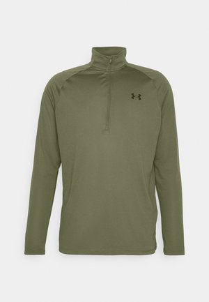 Olijfgroene ritsblouse met lange mouwen, gemaakt van gladde, rekbare stof. Kenmerkt een hoge kraag en een klein zwart logo op de borst.