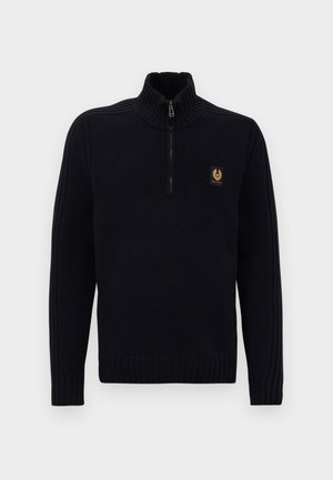 Mustmustriibuline kootud sviiter, millel on veerand tõmblukk ja kõrge krae, ning vasakul rinnal väike pruun logopatch.