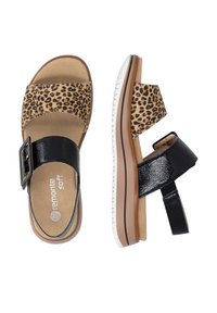 Pair of women's sandals with leopard print front strap and black patent buckle strap, cushioned tan footbed, and white-brown flexible sole.