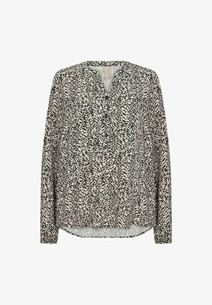 Long-sleeve blouse in patterned cream and black fabric. Features a V-neckline and relaxed fit. Textured design with abstract leaf motifs.