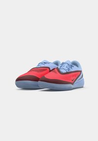 Blue and red athletic shoes featuring a textured upper, curved design, contrasting accents, and a lightweight rubber sole.