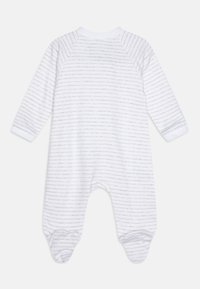 Hvit heldrakt med lysegrå horisontale striper. Den har lange ermer, rund hals og føtter. Myk stofftekstur.