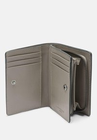 Leather wallet in light gray with multiple card slots, a zip compartment, and a snap closure. Smooth texture with subtle stitching details.