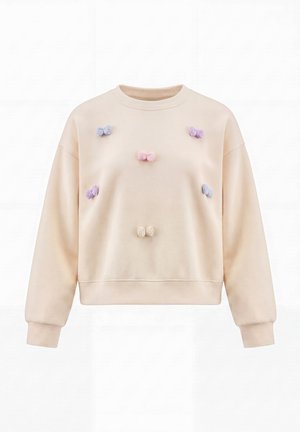 Beige sweatshirt med lange ærmer, dekoreret med små pastelfarvede sløjfer i lilla, lyserød og creme på forsiden. Ingen person er vist.
