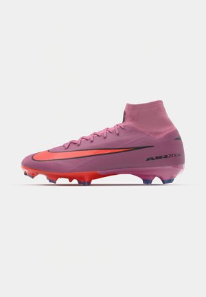 Pink football boots with a high collar, featuring a black Swoosh, red accents, and a textured surface. Equipped with multicolored studs.