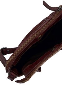 Brown leather bag with a soft texture, zip closure, and interior lining. Features gold hardware and a detachable strap.