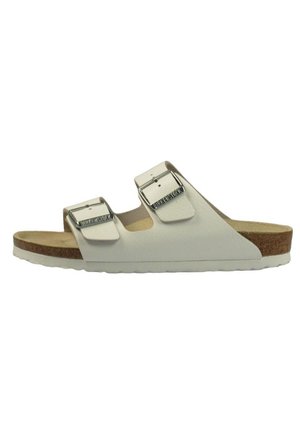 White sandal with two adjustable straps and metal buckles, cork footbed, and a flexible rubber sole. Smooth synthetic upper material.