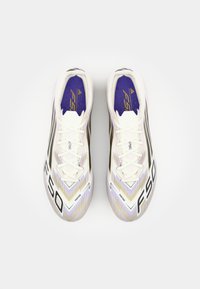 White football boots with purple and gold accents, featuring a textured design, laces, and a prominent "F50" logo on the side.