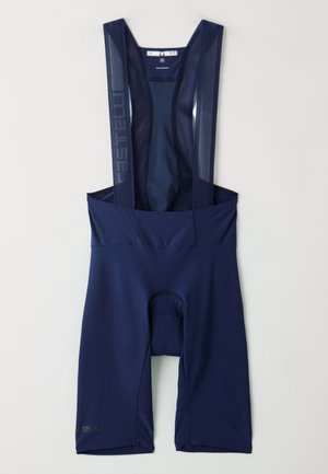 Marineblaue Radfahr-Bib-Shorts mit Netzträgern, gepolsterter Sitz und enganliegenden Beinöffnungen. Verfügt über dezente Branding auf dem linken Bein. Glattes, dehnbares Material.