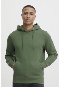 Olive green hoodie made of soft fabric, featuring a front pocket, drawstring hood, and subtle logo on the chest. Smooth texture and fitted design.