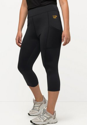 Black capri leggings with a wide waistband, featuring a textured side pocket and gold logo detail on the hip. Smooth, stretchy fabric.